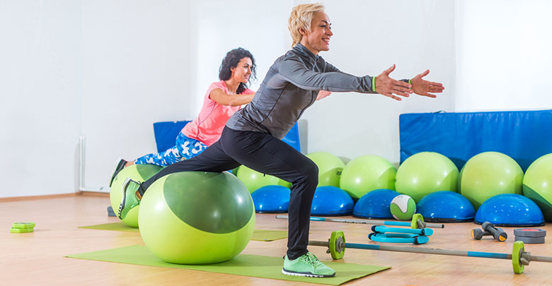 Two woman are doing Pilates ball work for their arthritis. 